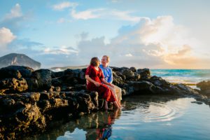 Husband and wife sitting in a tide pool