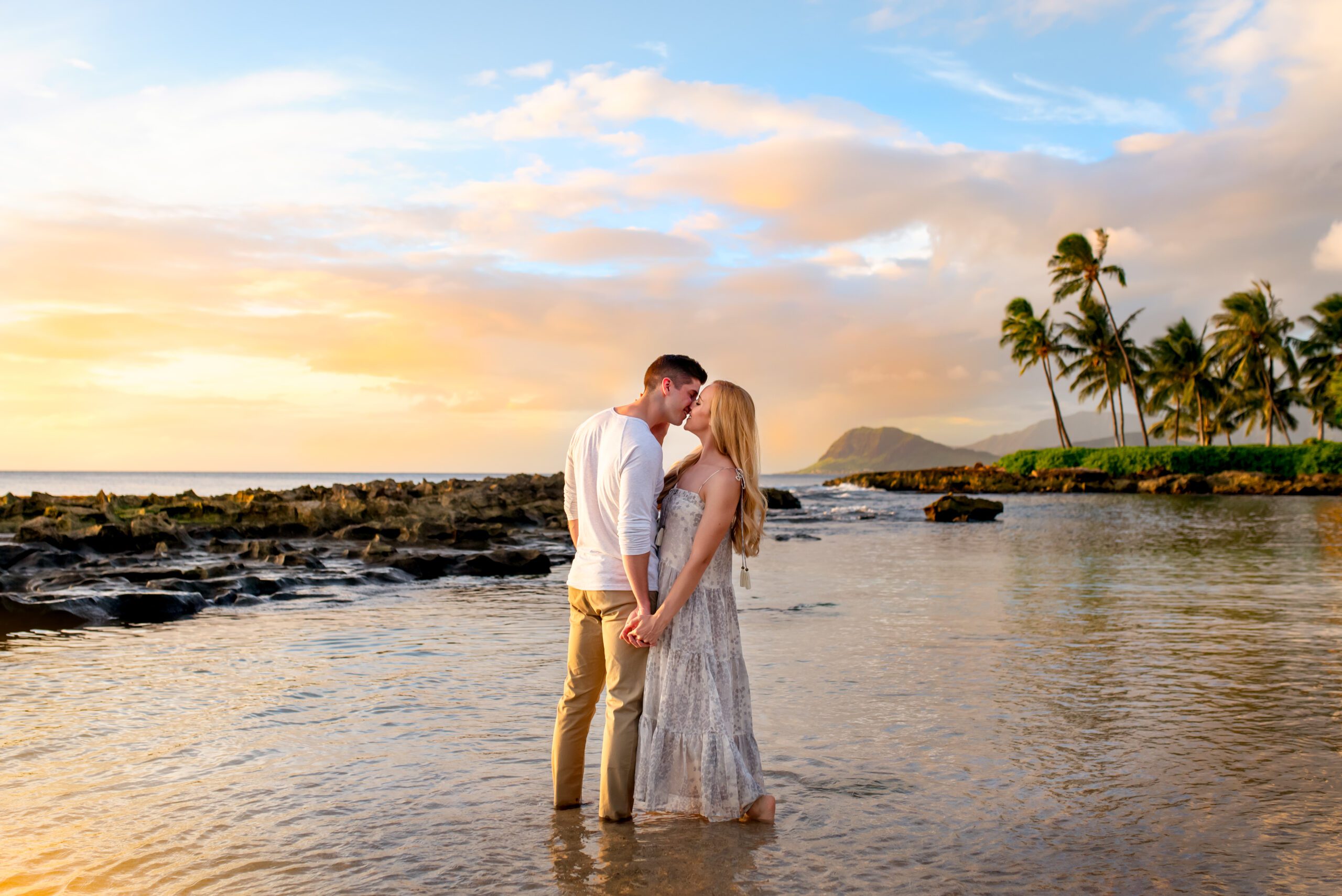 couple kissing on a Hawaiian beach at sunset